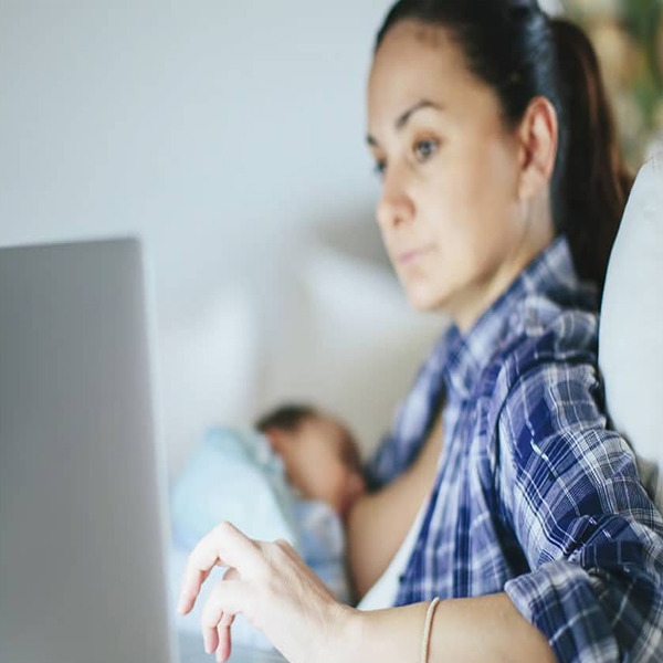 Woman on an online breastfeeding consultation with her baby